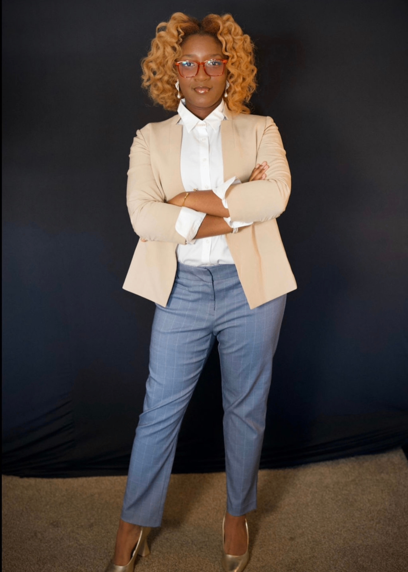 Nzinga Collins today, standing with arms crossed